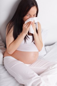Pregnant woman sneezing