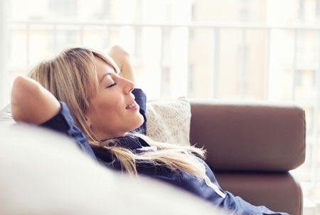 Content young woman lying on couch