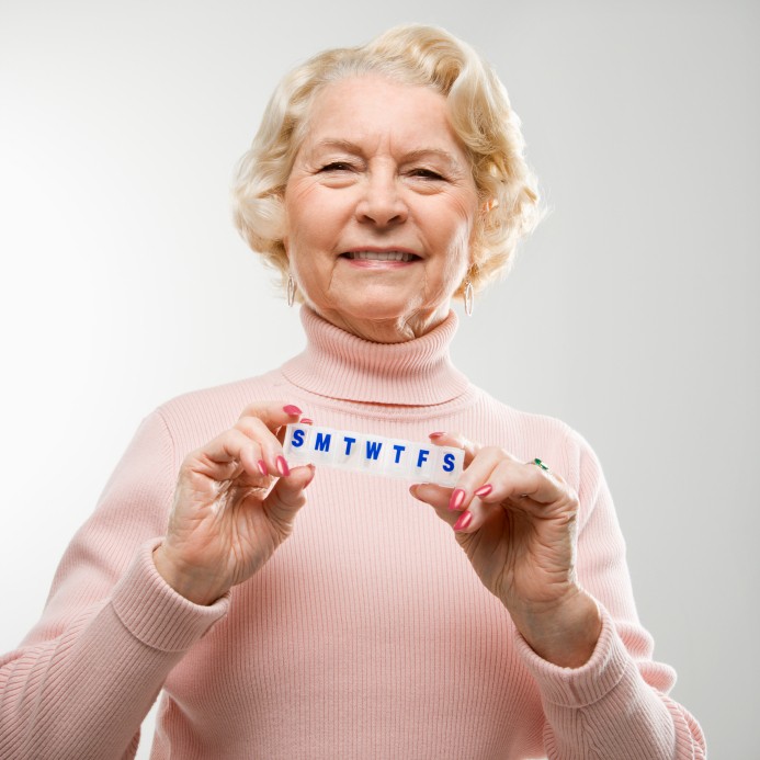 elderly woman with pills