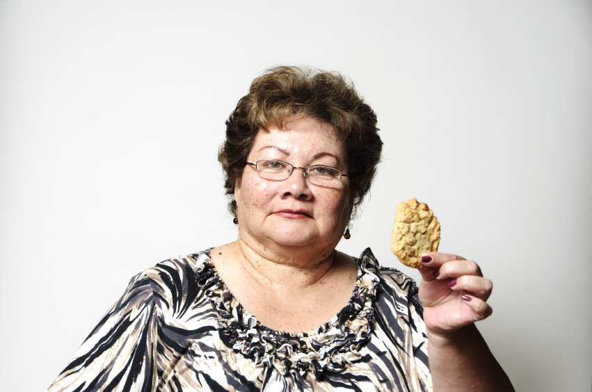 woman considering eating a cookie